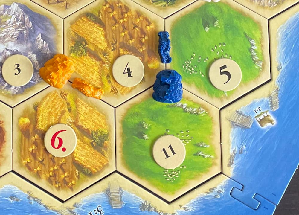 Settlers of Catan blue player places 2nd settlement