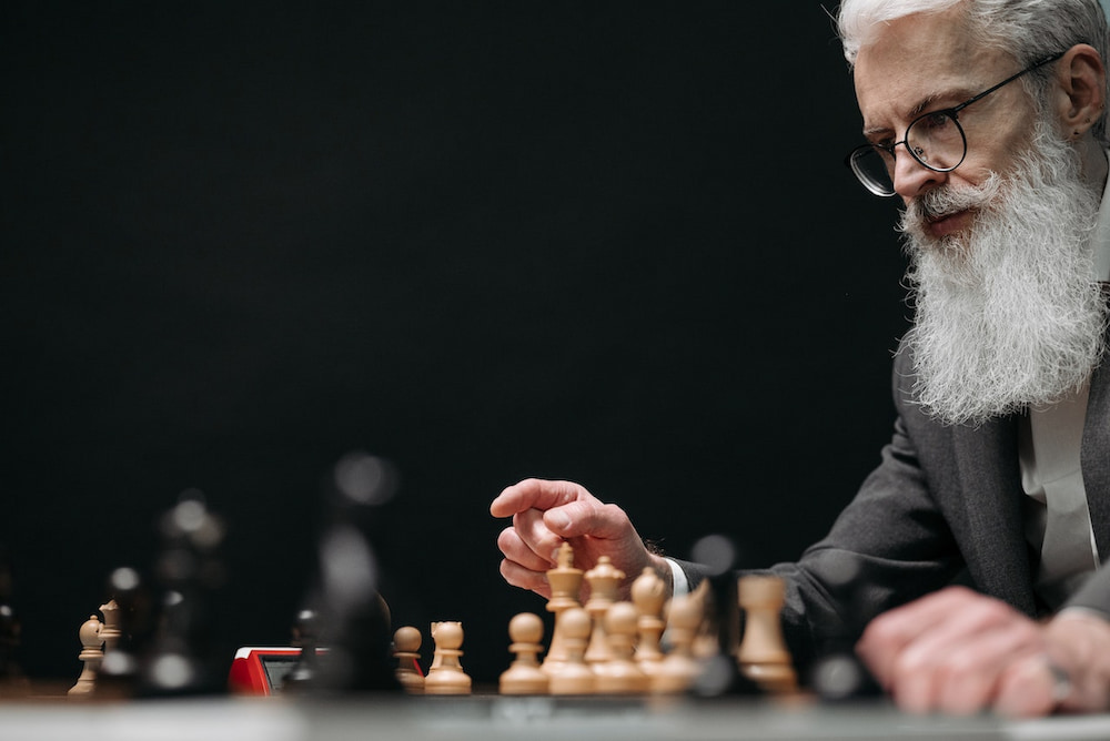 older person playing chess